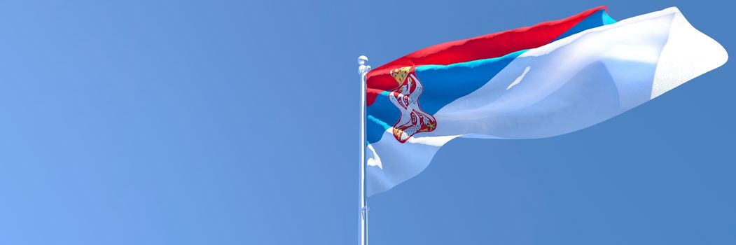 3D rendering of the national flag of Serbia waving in the wind against a blue sky