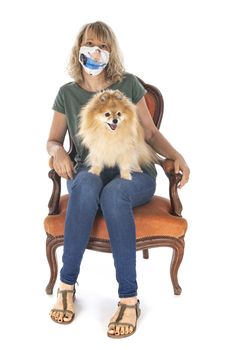 little dog and woman on chair in front of white background