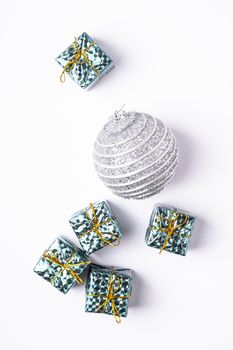 Christmas New Year composition. Gifts, silver ball decorations on white background. Winter holidays concept. Flat lay, top view