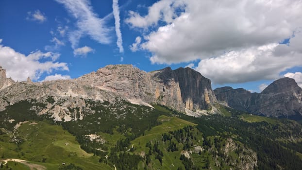 Val Gardena, Italy - 09/15/2020: Scenic alpine place with magical Dolomites mountains in background, amazing clouds and blue sky in Trentino Alto Adige region, Italy, Europe