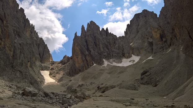 Val Gardena, Italy - 09/15/2020: Scenic alpine place with magical Dolomites mountains in background, amazing clouds and blue sky in Trentino Alto Adige region, Italy, Europe