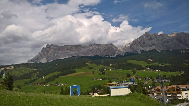 Val Gardena, Italy - 09/15/2020: Scenic alpine place with magical Dolomites mountains in background, amazing clouds and blue sky in Trentino Alto Adige region, Italy, Europe