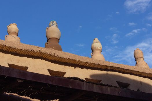 Ait Ben Haddou ksar Morocco, ancient fortress that is a Unesco Heritage site. Beautiful late afternoon light with honey, gold coloured mud brick construction the kasbah, or fortified town dates from 11th cent. and is on the former caravan route from the Sahara and Marrakech. The location has been used for many famous movies. High quality photo