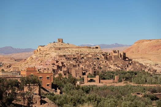 Ait Ben Haddou ksar Morocco, ancient fortress that is a Unesco Heritage site. Beautiful late afternoon light with honey, gold coloured mud brick construction the kasbah, or fortified town dates from 11th cent. and is on the former caravan route from the Sahara and Marrakech. The location has been used for many famous movies. High quality photo