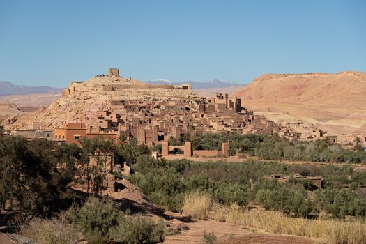 Ait Ben Haddou ksar Morocco, ancient fortress that is a Unesco Heritage site. Beautiful late afternoon light with honey, gold coloured mud brick construction the kasbah, or fortified town dates from 11th cent. and is on the former caravan route from the Sahara and Marrakech. The location has been used for many famous movies. High quality photo