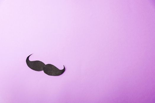 Black mustache paper, studio shot isolated on purple background, Prostate cancer awareness month, Fathers day, minimal November moustache concept