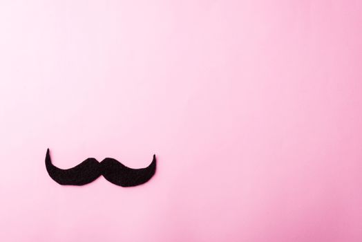 Black mustache paper, studio shot isolated on pink background, Prostate cancer awareness month, Fathers day, minimal November moustache concept