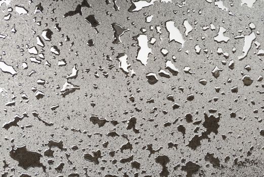 New asphalt after rain. Grunge texture. Stock photography.