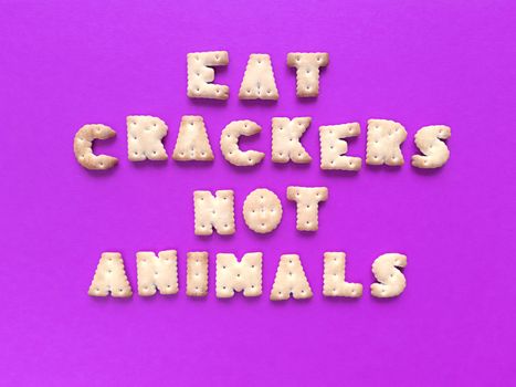 Eat crackers, not animals. Food typography on pink background. Vegan concept. Stock photography.