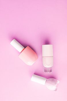 Nail polish bottles on pink background, beauty branding