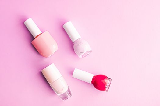 Nail polish bottles on pink background, beauty branding