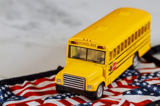 Small town school bus and american flag background
