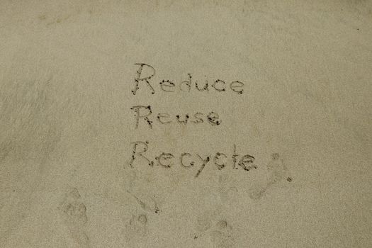 reduce reuse recycle concept drawn on sand, sustainability.
