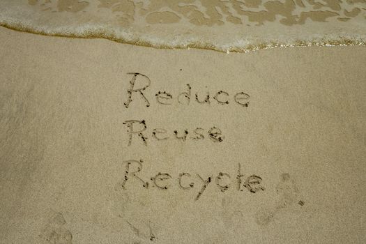 reduce reuse recycle concept drawn on sand, sustainability.