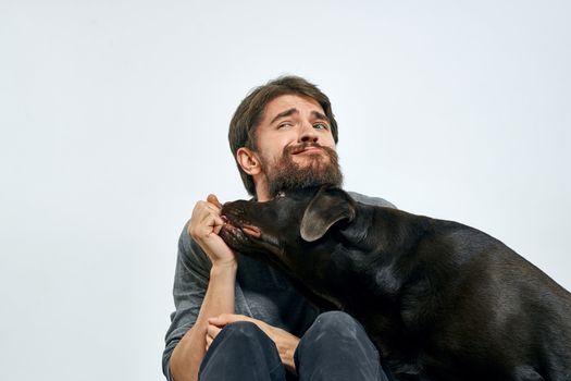 happy owner with pet black dog training model emotions. High quality photo