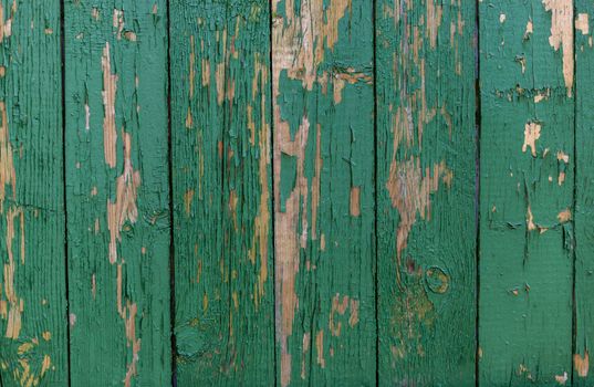 Dark green scratched grunge Wooden textured wall. Old wood texture with peeling paint.