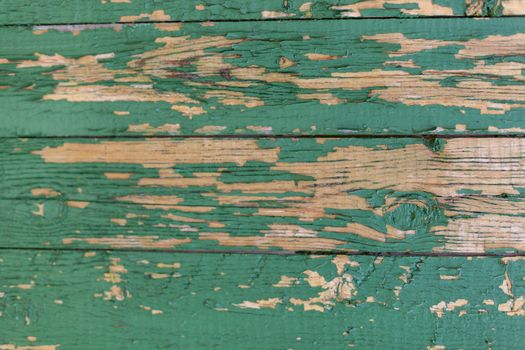 Dark green scratched grunge Wooden textured wall. Old wood texture with peeling paint.