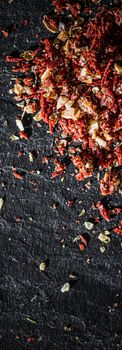 Dried tomato and chili pepper closeup on luxury stone background as flat lay, dry food spices and recipe ingredients