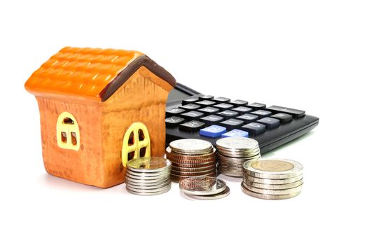 Model house with coin, calculator concept Collecting money Buying a house, residence, business finance