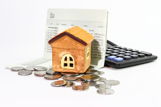 Model house with coin, calculator, book bank, concept 
Collecting money Buying a house, residence, business, finance