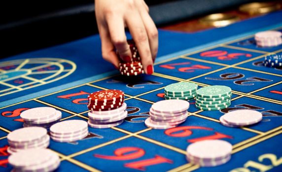 Betting and playing roulette in casino, gambling ads