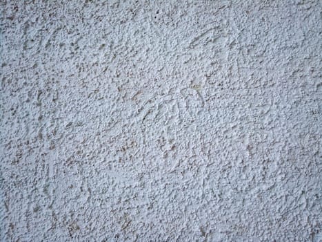 Cement-gypsum fur coat. Street plaster on the wall. Texture, large bulges.White empty background. Finishing of building facades