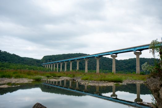 The Norman Wood Bridge OVer the Susquehanna River Reflecting Itself in a Small Body of Water on a Cloudy Day