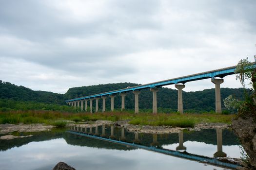 The Norman Wood Bridge OVer the Susquehanna River Reflecting Itself in a Small Body of Water on a Cloudy Day