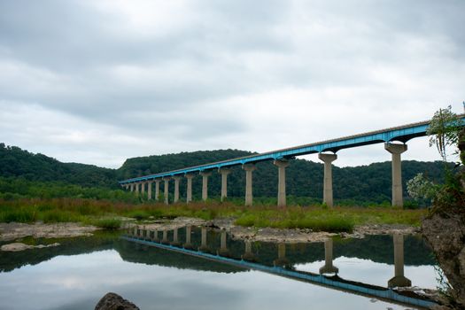 The Norman Wood Bridge OVer the Susquehanna River Reflecting Itself in a Small Body of Water on a Cloudy Day