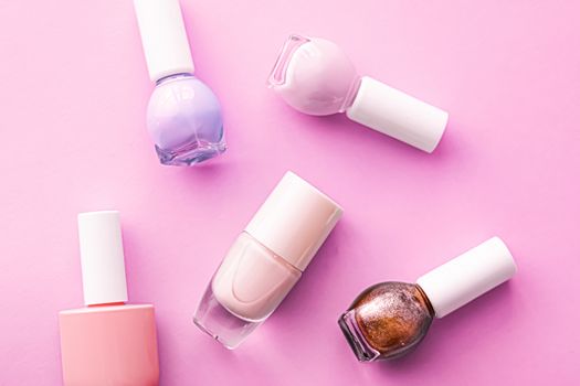 Nail polish bottles on pink background, beauty branding