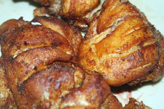 Fried, grilled baked chicken pieces with marinated spices on it. Tasty delicious fried chicken barbecue