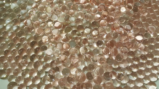 Closeup view with selective focus of shiny glittering orbeez or colorful water balls hydrogel. Water beads orbeez background.