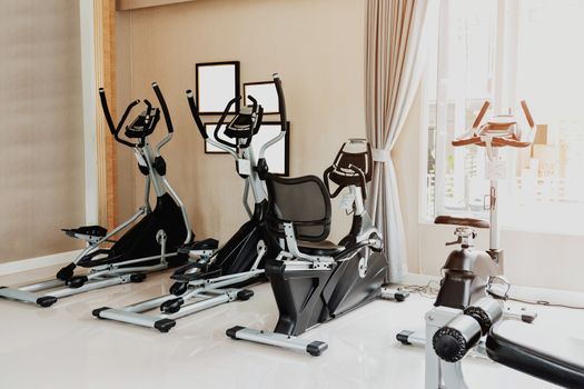 Empty gym or exercise room has many types of equipment but no one uses them, Concept for exercise and health care.