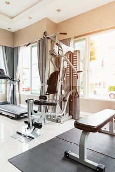 Empty gym or exercise room has many types of equipment but no one uses them.