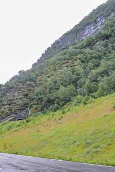 Beautiful wet road to a tunnel in the mountains in Hemsedal in Viken, Norway.