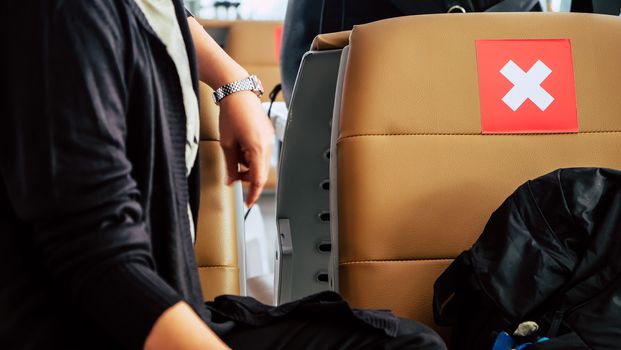 Social distancing, Rows of empty chairs in an airport's departure area marked with symbols regarding social distancing protocol to prevent the spreading of novel corona virus, COVID-19 in Thailand