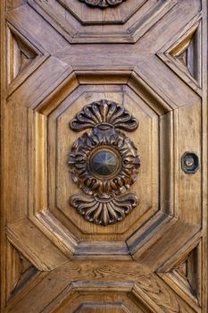 old ornate wooden door with beautiful carvings in italy