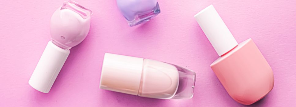 Nail polish bottles on pink background, beauty branding