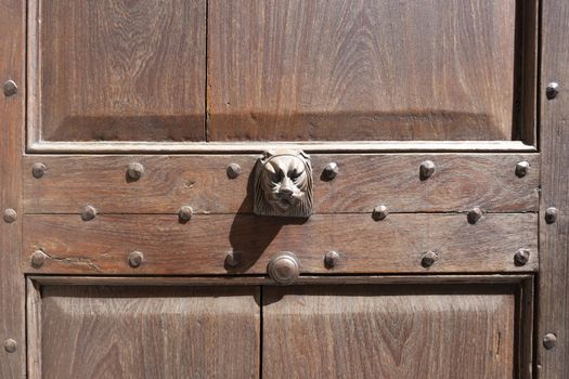 old ornate wooden door with beautiful carvings in italy