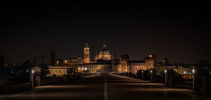 Night view of Mantua city coming from San Giorgio bridge, landscape of historical Lombard city in Italy