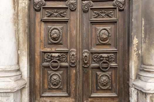 Classic painted wooden door with bronze handles in Paris