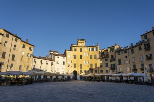 Amphitheater square in Lucca in the mornig sun. Tuscany, Italy