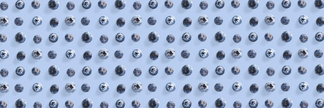 Background of Freshly picked blueberries on blue backdrop. Blackberry modern flatlay background. banner wide shot
