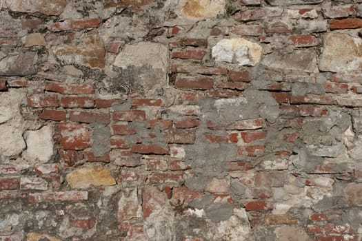 Background of old vintage dirty brick wall with peeling plaster, texture