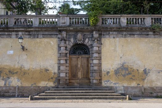 An old doorway with stairs in the city of Lucca, Tuscany, Italy.