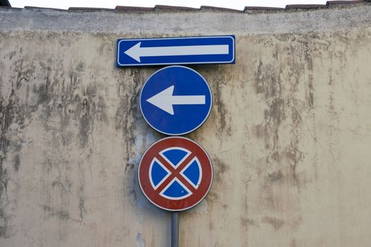 Several Traffic signs on old wall in italy