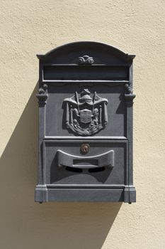 Old red Italian mail box on a wall in italy