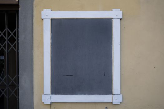 A chalk board with menu items resting against a wall.