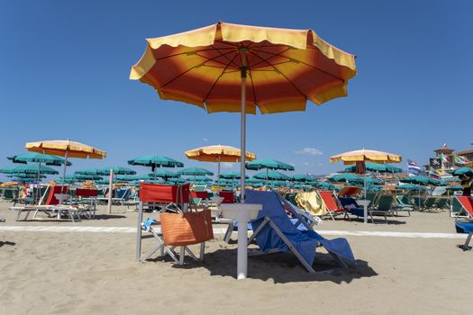 Summer beach landscape with umbrellas and beach chairs in italy