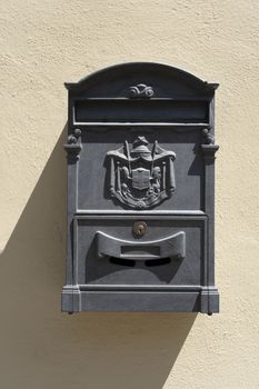 Old red Italian mail box on a wall in Lucca, italy